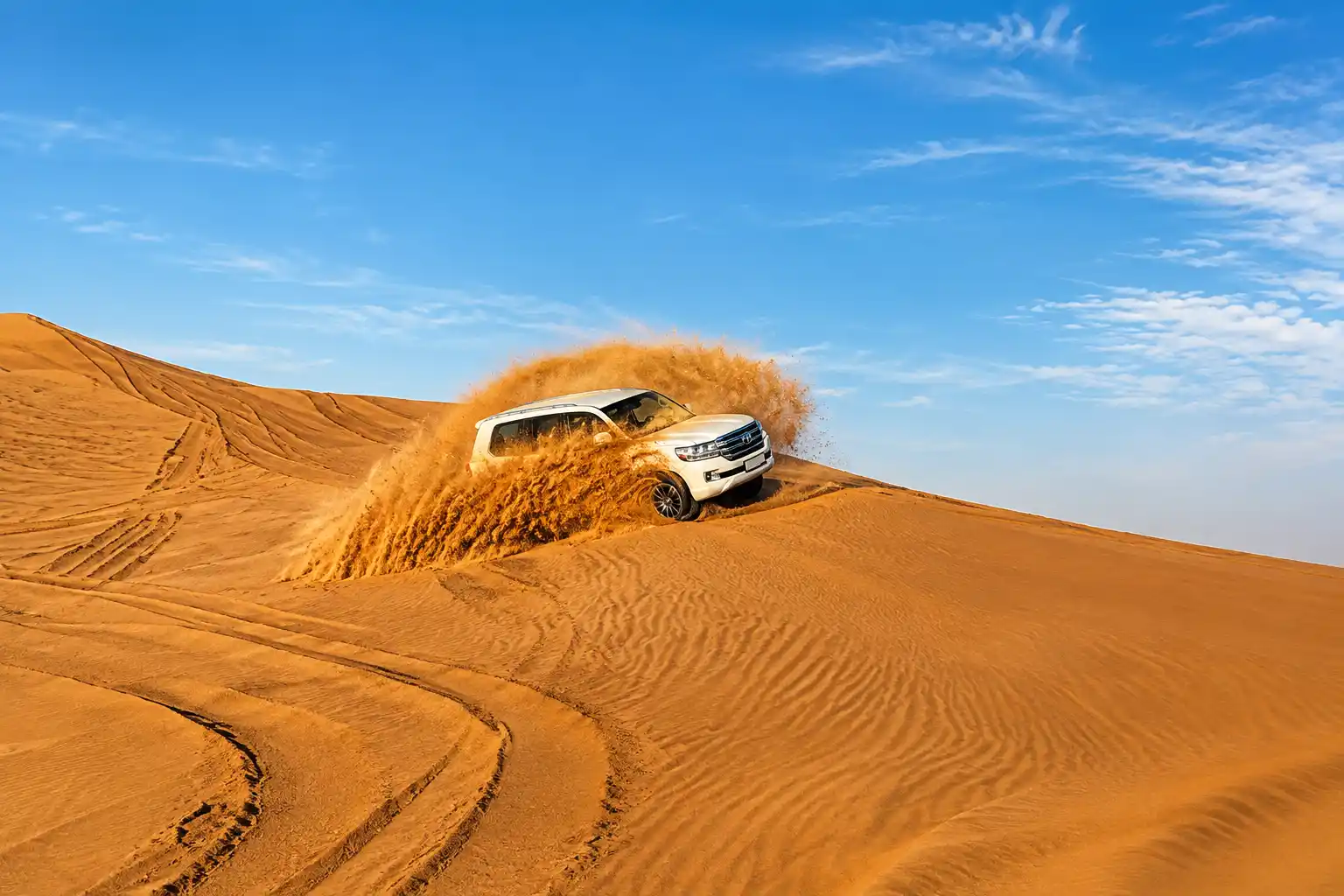 Safari vehicles on dunes in Dubai desert weather